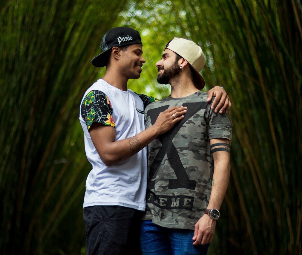 Gay couple embracing in bamboo forest