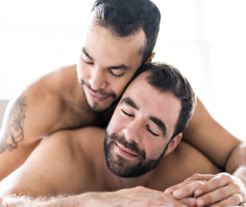 Naked gay couple laying on each other