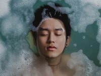 Young man eyes closed in water
