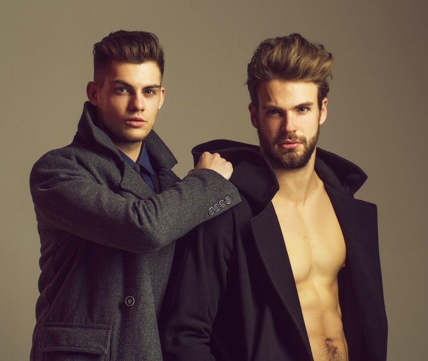 Two men in coats with one shirtless