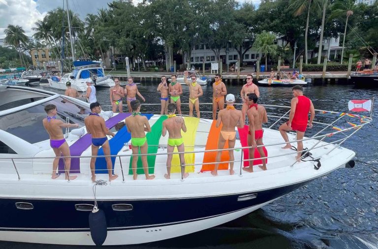 Twink boys in rainbow bikinis on boat